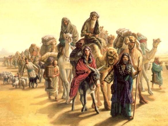 A group of travelers crossing the desert with camels and a donkey