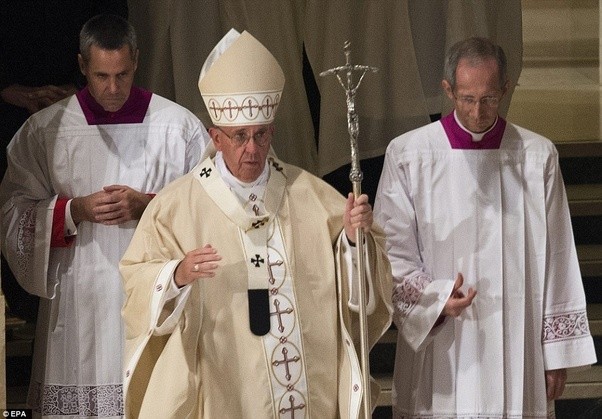 Pope Francis with two attendants