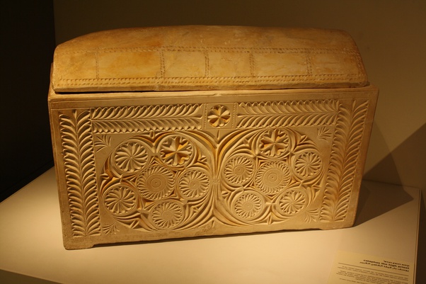 An ornate stone ossuary carved with floral and geometric patterns