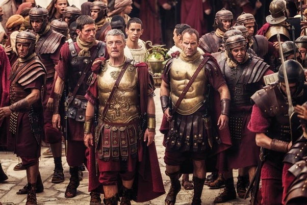 Roman soldiers standing in formation with shields and spears