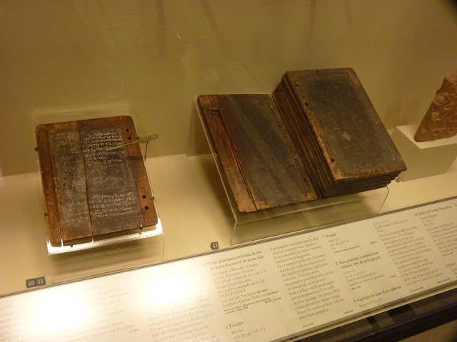 Ancient wax tablets and documents on display in a museum case
